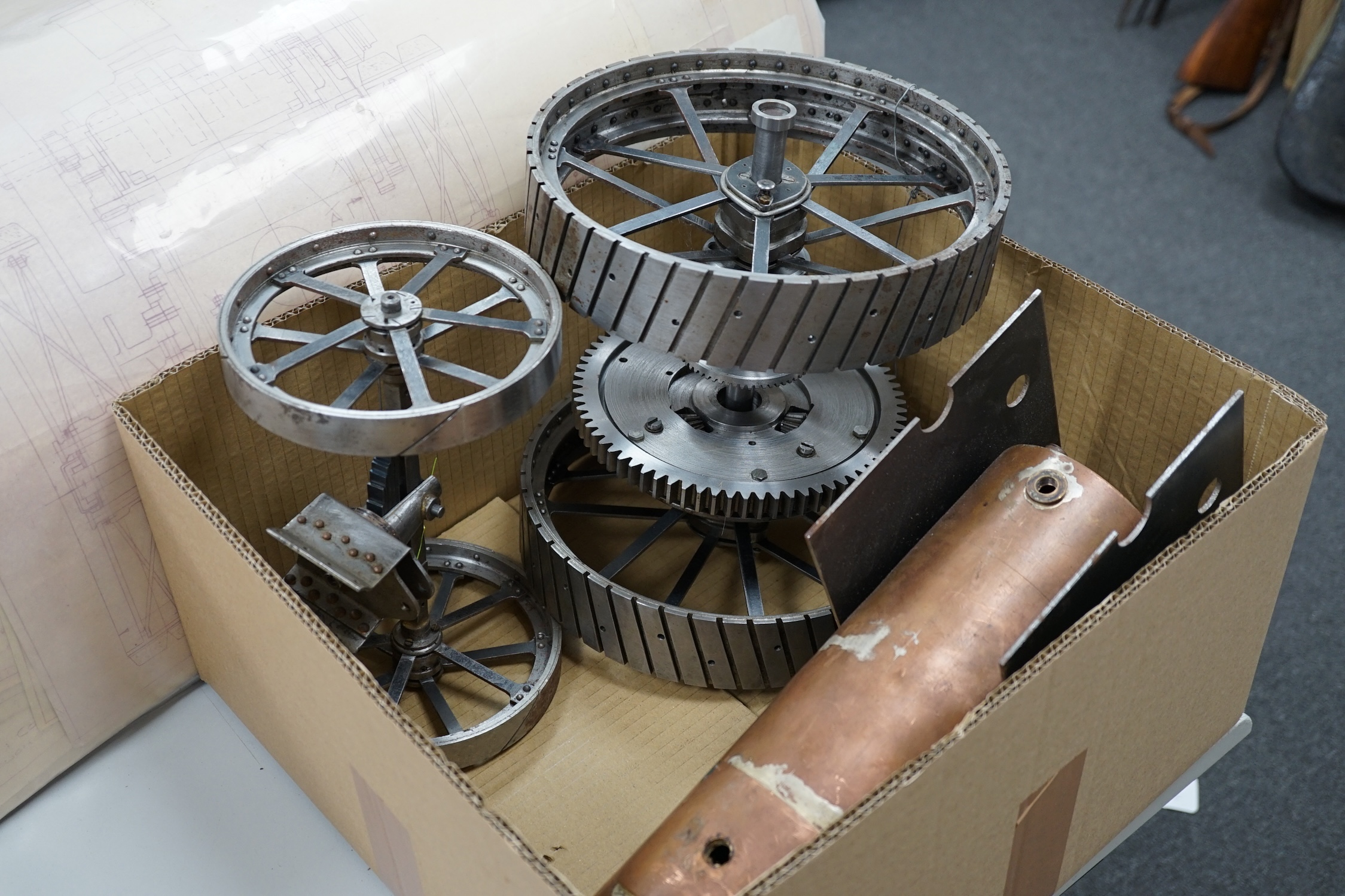 A partially constructed kit comprising of the major components of machined and cast parts to build a two inch scale live steam Ransomes 4 N.H.P. traction engine, including a set of drawings